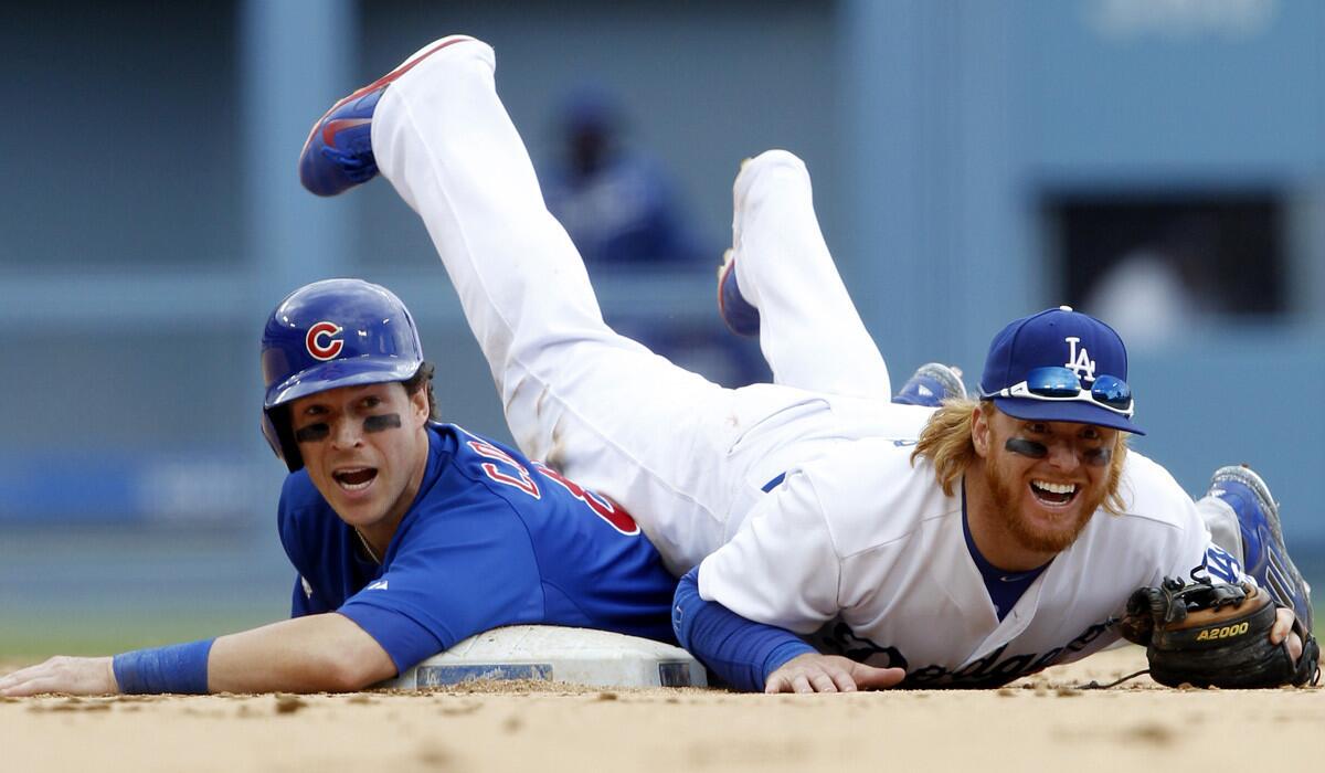 Dodgers second baseman Justin Turner is upended by the Cubs' Chris Coghlan, who broke up a double-play attempt in the seventh inning Sunday.
