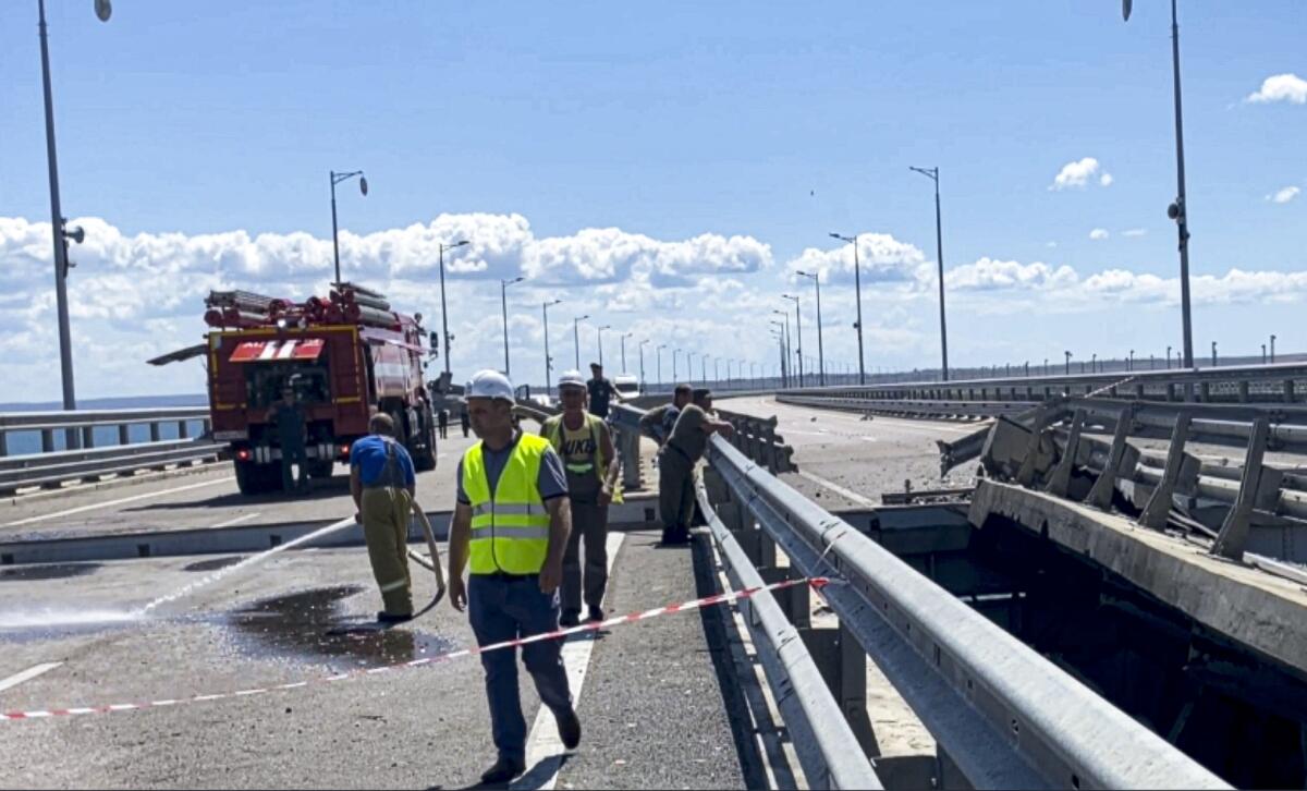 Workers repairing damaged Russia-Crimea bridge