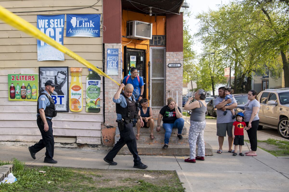 Chicago police work the scene of a fatal shooting in the Back of the Yards neighborhood, in Chicago, Tuesday, May 10, 2022. (Tyler Pasciak LaRiviere /Chicago Sun-Times via AP)