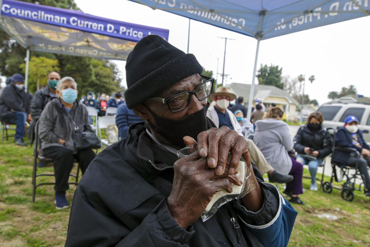 Anthony Angulo, 71, waits for his COVID-19 vaccination.