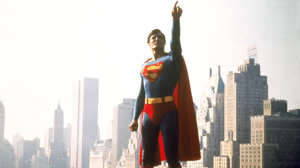 Christopher Reeve as Superman in front of tall buildings in 'Super/Man: The Christopher Reeve Story.'
