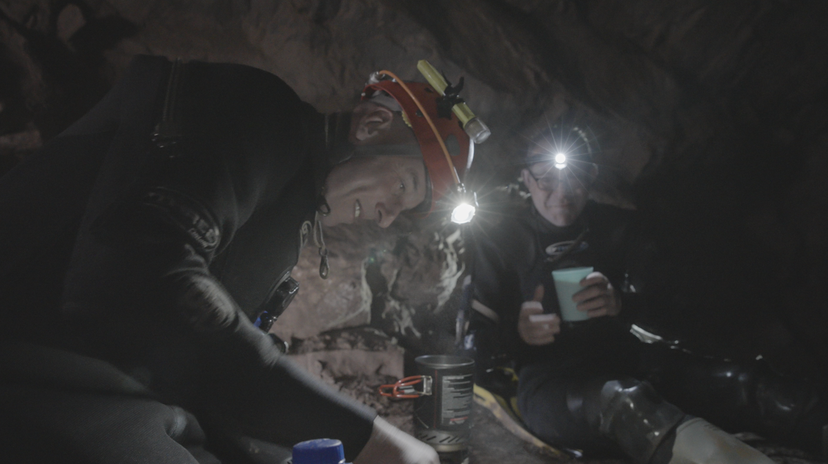Two headlamp-wearing divers at work.