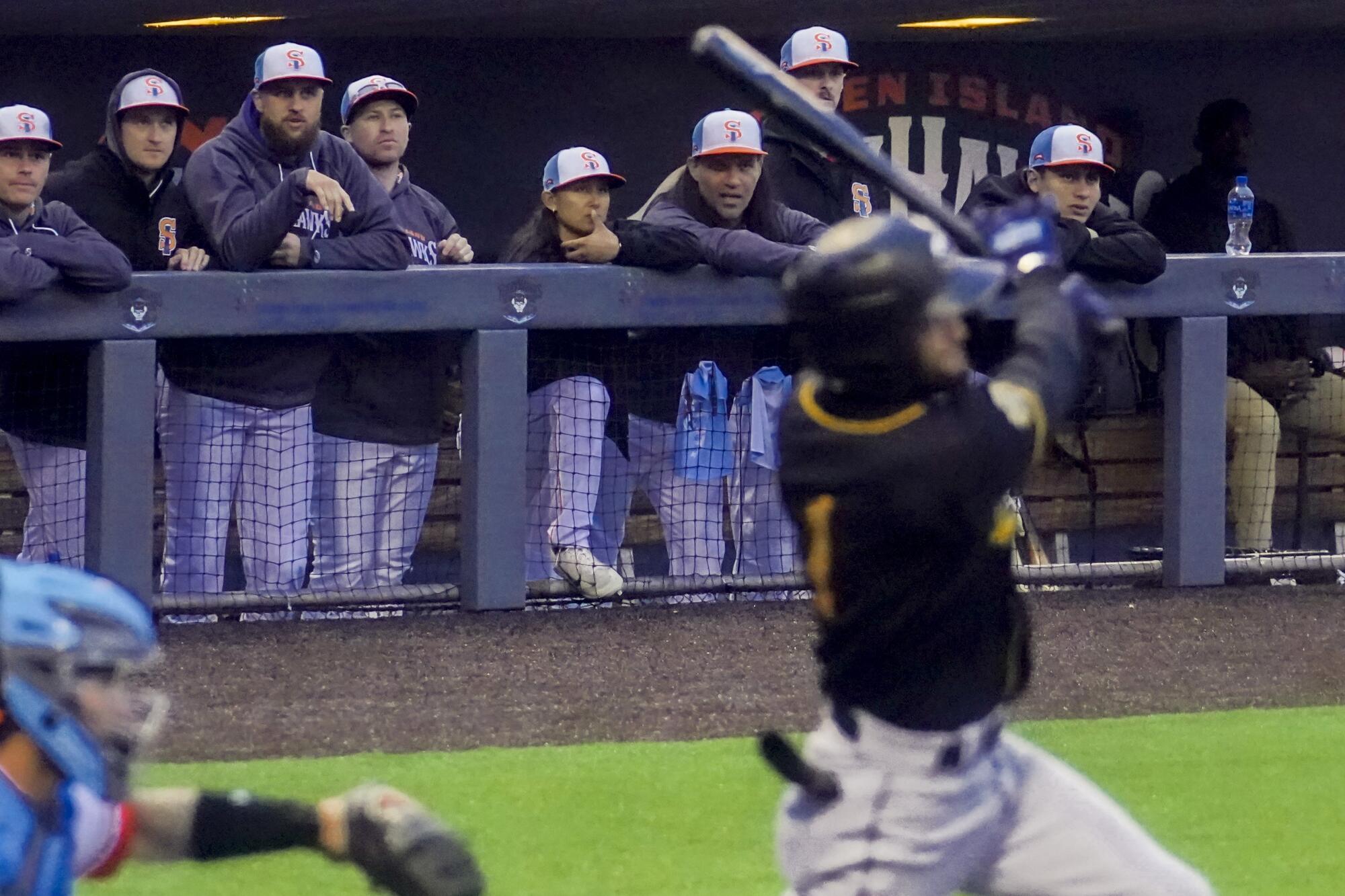 Kelsie Whitmore watches from dugout with teammates during a game against Gastonia on May 13 in New York. 