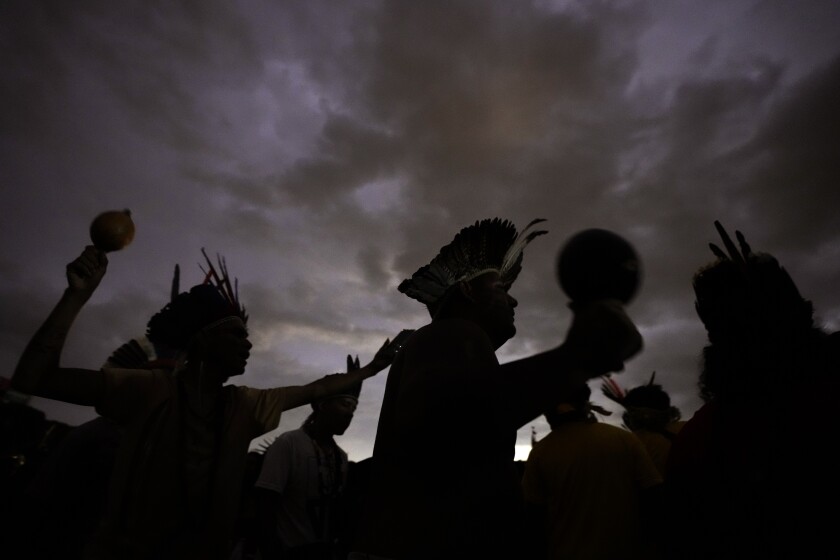 FILE - Indigenous people take part in a march during the 18th annual Free Land Indigenous Camp, in Brasilia, Brazil, Wednesday, April 13, 2022. Brazilian environmental and Indigenous organizations, together with some companies, are in a letter released late Monday, May 9, urging the United States to come through with promised funding for forest protection and to deal directly with people who live in the forest, have protected it and “are directly affected by the escalating deforestation.” (AP Photo/Eraldo Peres, File)