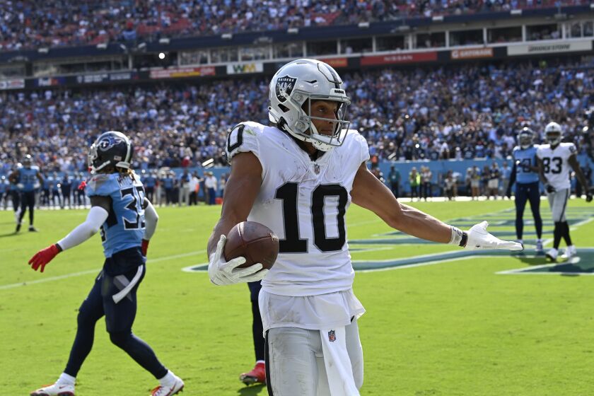 Las Vegas Raiders wide receiver Mack Hollins (10) celebrates after catching a touchdown pass against the Tennessee Titans late in the fourth quarter of an NFL football game Sunday, Sept. 25, 2022, in Nashville, Tenn. (AP Photo/Mark Zaleski)