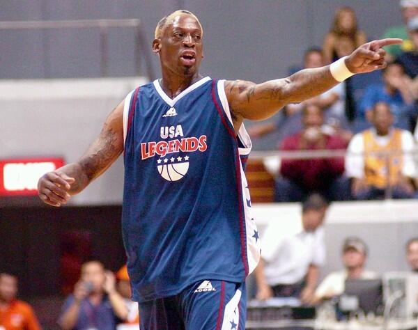 Former NBA star Dennis Rodman points to teammates during the "Bad Boy Tour" exhibition game against Team Philippines in Manila. Rodman scored two and made 16 rebounds for his team but Team Philippines won against the Rodman-powered USA Legends 110-102.