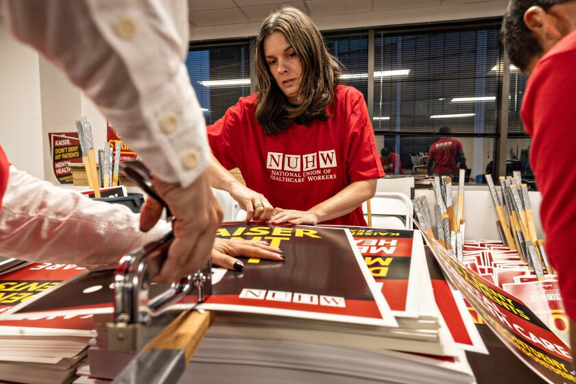 Glendale, CA - October 16: Maggie Sisco along with other members of the National Union of Healthcare Workers make signs at a Glendale union office for a potential strike on Wednesday, Oct. 16, 2024 in Glendale, CA. (Jason Armond / Los Angeles Times)