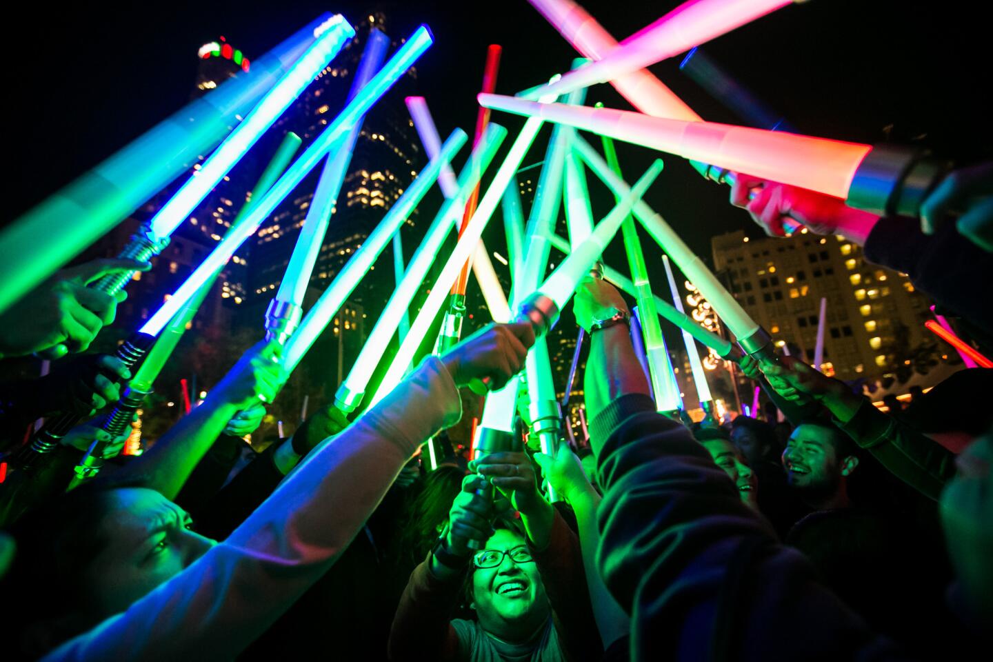 In the ultimate nocturnal showdown, thousands attend a lightsaber battle in downtown L.A.'s Pershing Square to celebrate the opening weekend of the new movie "Star Wars: The Force Awakens."
