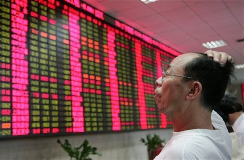 An investor looks at the stock price monitor at a private securities company Thursday, Sept. 9, 2010 in Shanghai, China. Chinese shares fell Thursday on fears of possible new government curbs on real estate as investors waited for monthly economic data. The benchmark Shanghai Composite Index lost 38.94 points, or 1.4 percent, to close at 2,656.35. The Shenzhen Composite Index for China's smaller second exchange also shed 1.4 percent to end at 1,179.13. (AP Photo)