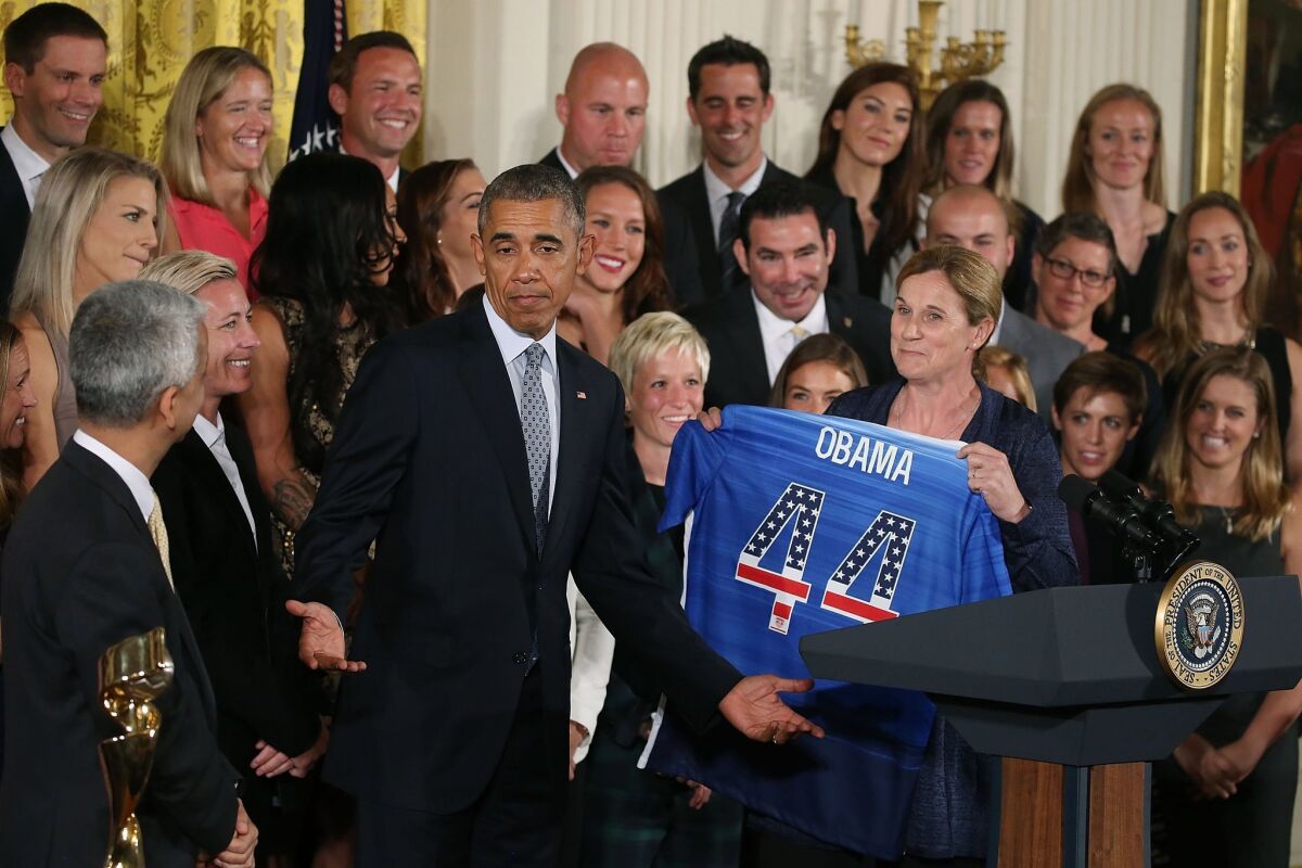 President Obama is presented with a jersey by the U.S. women's soccer team Tuesday at the White House.