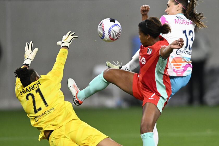 San Diego WaveOs Alex Morgan (13) shoots past Kansas City CurrentOs Elizabeth Ball (7) and Ad Franch (21) during the first half of an NWSL soccer game March, 23, 2024 in San Diego, Calif. (Photo by Denis Poroy)