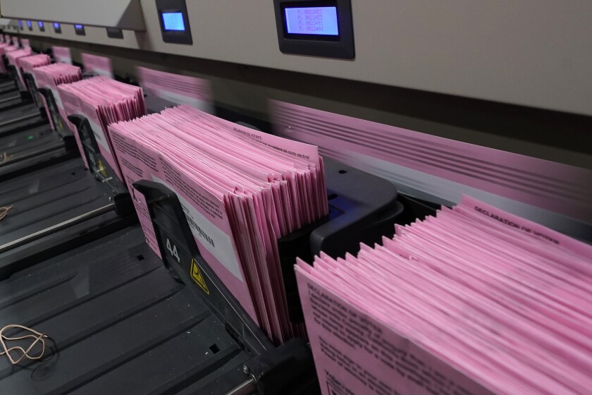 Stacks of mail ballots in a voting machine. 