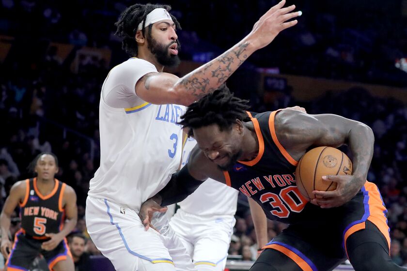 LOS ANGELES, CALIF. - MAR. 12, 2023. Lakers center Anthony Davis defends against Knicks forward Julius Randle in the second half at Crypto.com Arena in Los Angeles on Sunday, Mar. 12, 2023. The Knicks won, 112-108. (Luis Sinco / Los Angeles Times)
