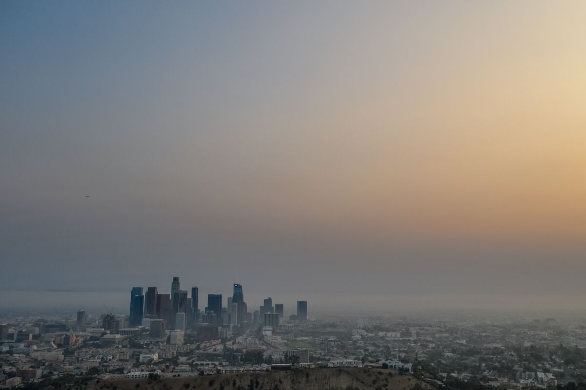 The downtown Los Angeles skyline peaks out above a layer of smog in 2020.