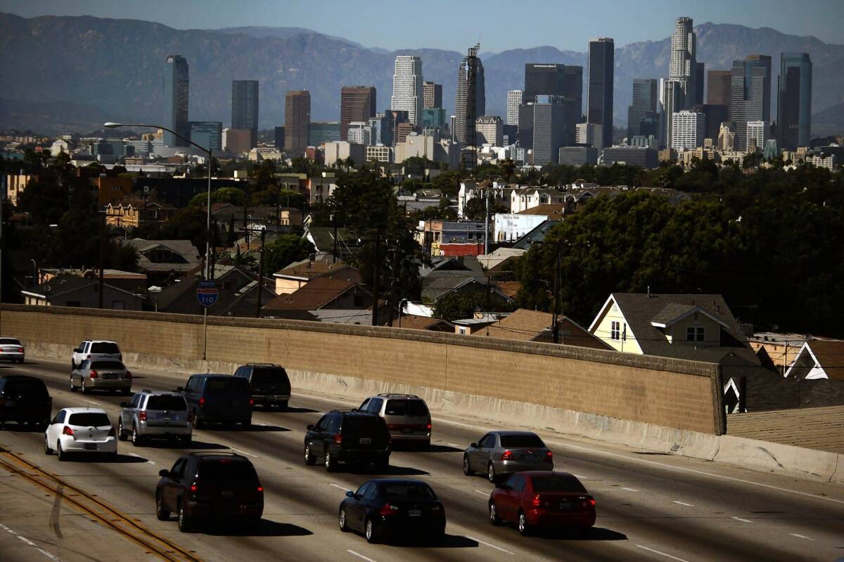 On a clear day in downtown Los Angeles, traffic travels north on the 110 Freeway. Despite a threefold increase in people and cars in the last 50 years, California's strict vehicle emissions standards have managed to significantly clear the state's air, according to new research.