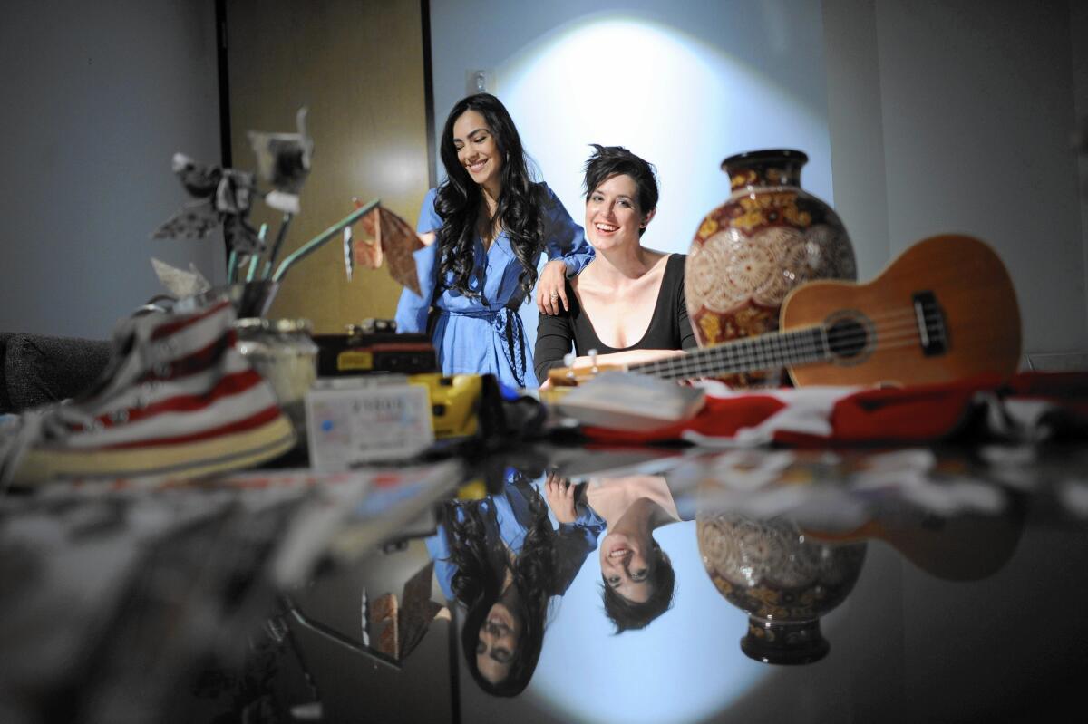 Assistant director Amanda Vandenberg, left, and Director Alexis Hyde with submissions to the Museum of Broken Relationships.