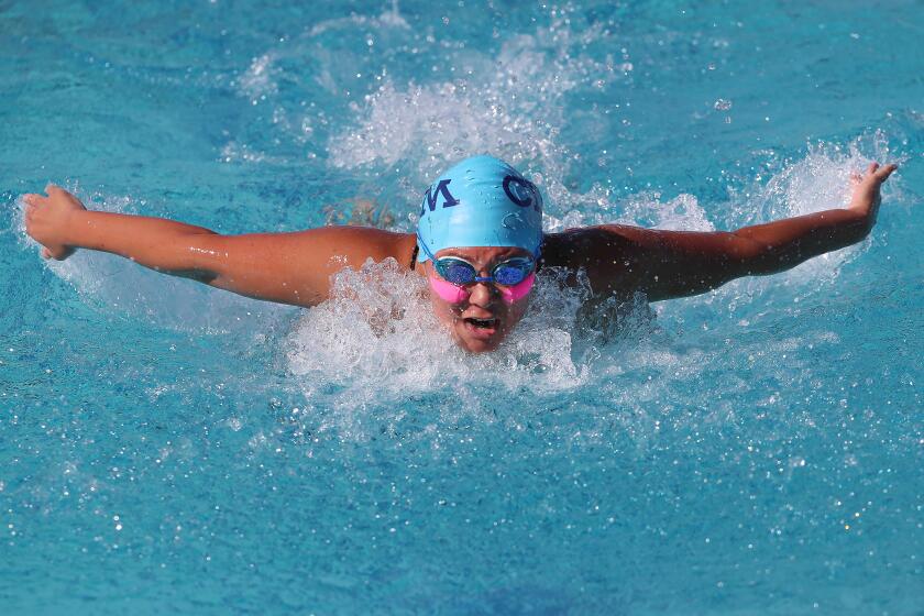 Corona del Mar's Taylor Park swims the girls' 100 butterfly in the Battle of the Bay swim meet against Newport Harbor on Tuesday.