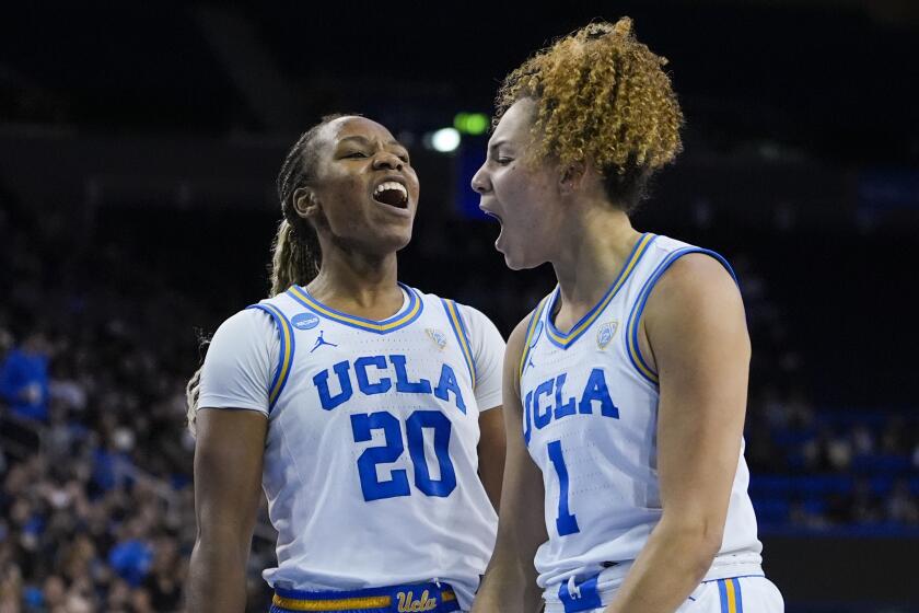 UCLA guard Kiki Rice, right, celebrates with Charisma Osborne against Cal Baptist at Pauley Pavilion.