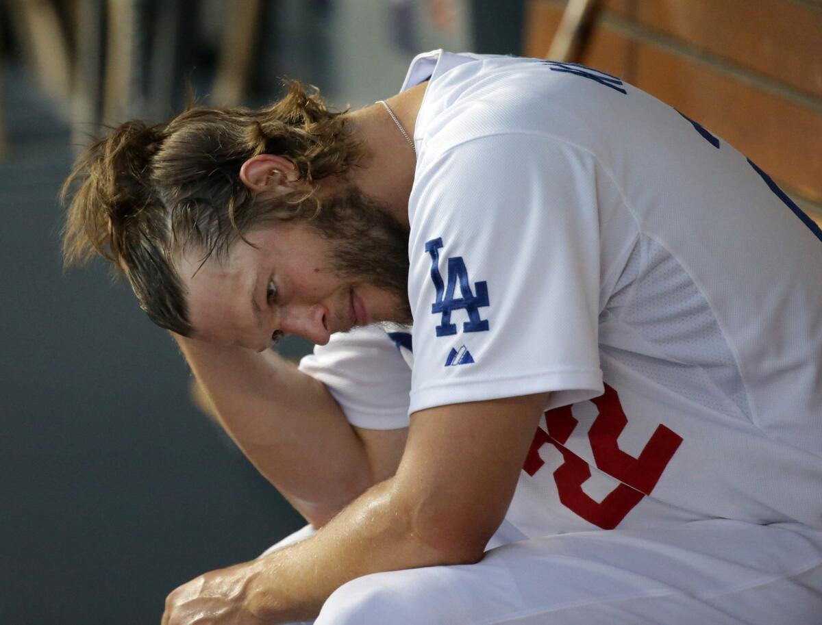 Dodgers pitcher Clayton Kershaw sits in the dugout during Game 1 against the St. Louis Cardinals on Friday.
