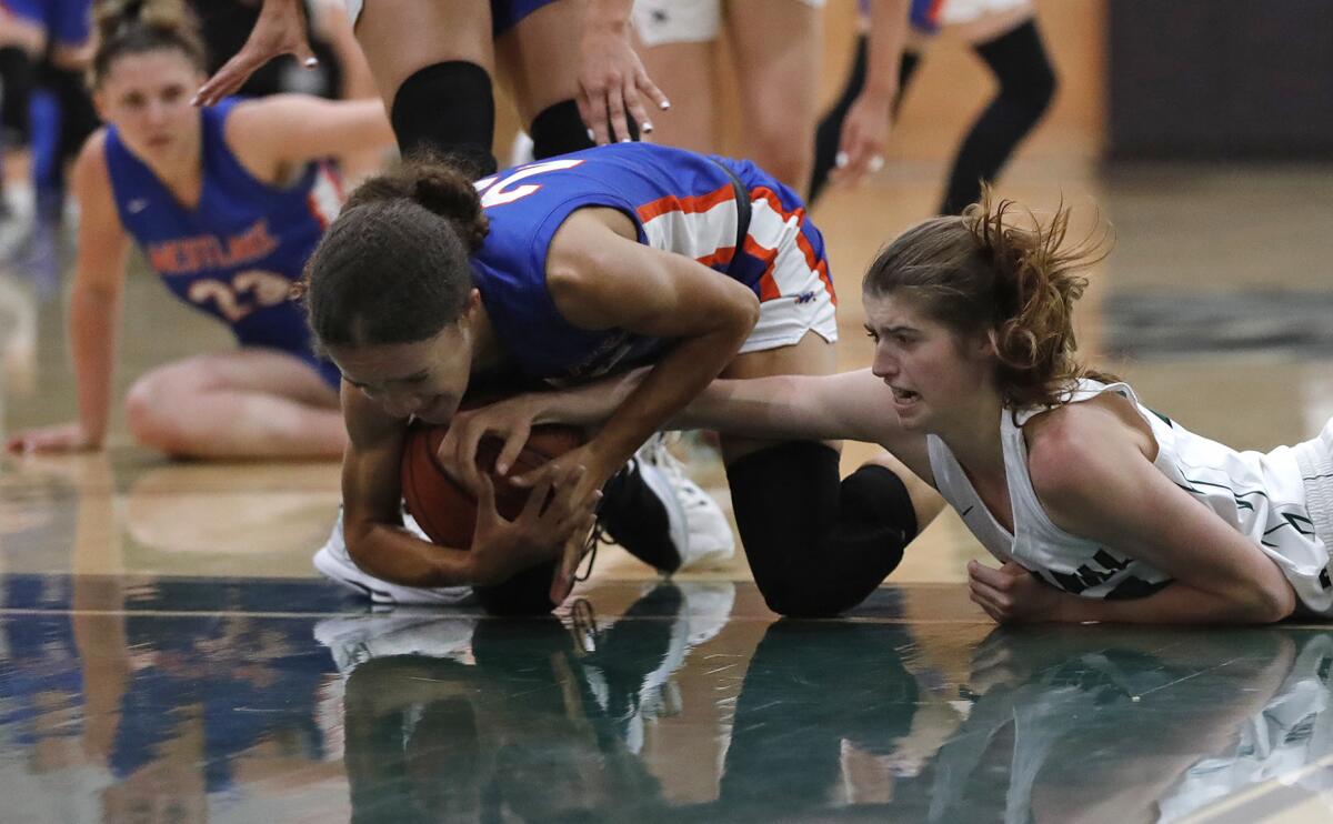 Westlake's London Gamble and Sage Hill's Isabel Gomez dive for a loose ball in the fourth quarter.