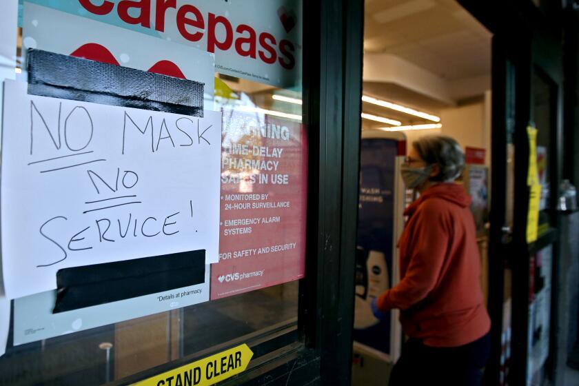 The CVS store on the 500 block of N. Hollywood Way has a sign reminding customers to wear a face mask, in Burbank on Wednesday, April 15, 2020.
