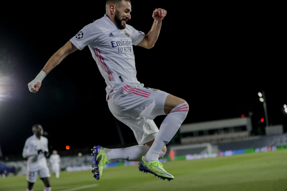 Real Madrid's Karim Benzema celebrates after scoring his side's second goal during the Champions League group B soccer match between Real Madrid and Borussia Monchengladbach at the Alfredo Di Stefano stadium in Madrid, Spain, Wednesday, Dec. 9, 2020. (AP Photo/Bernat Armangue)
