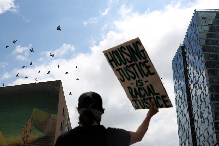 A pro-tenant demonstrator marches in downtown Los Angeles in June.