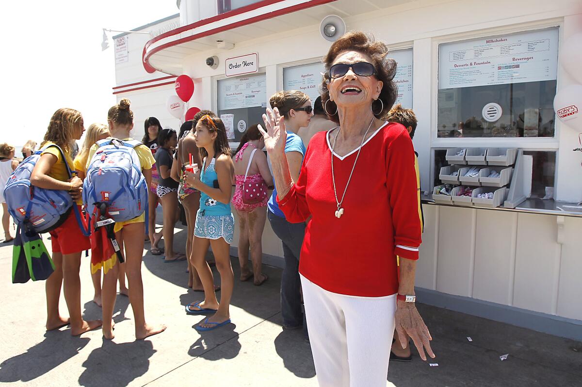 Ruby Cavanaugh, the namesake for Ruby's Diner, waves to guests at the original restaurant at the end of the Balboa Pier in 2012, when the chain turned 30. Cavanaugh died Sunday at age 93.