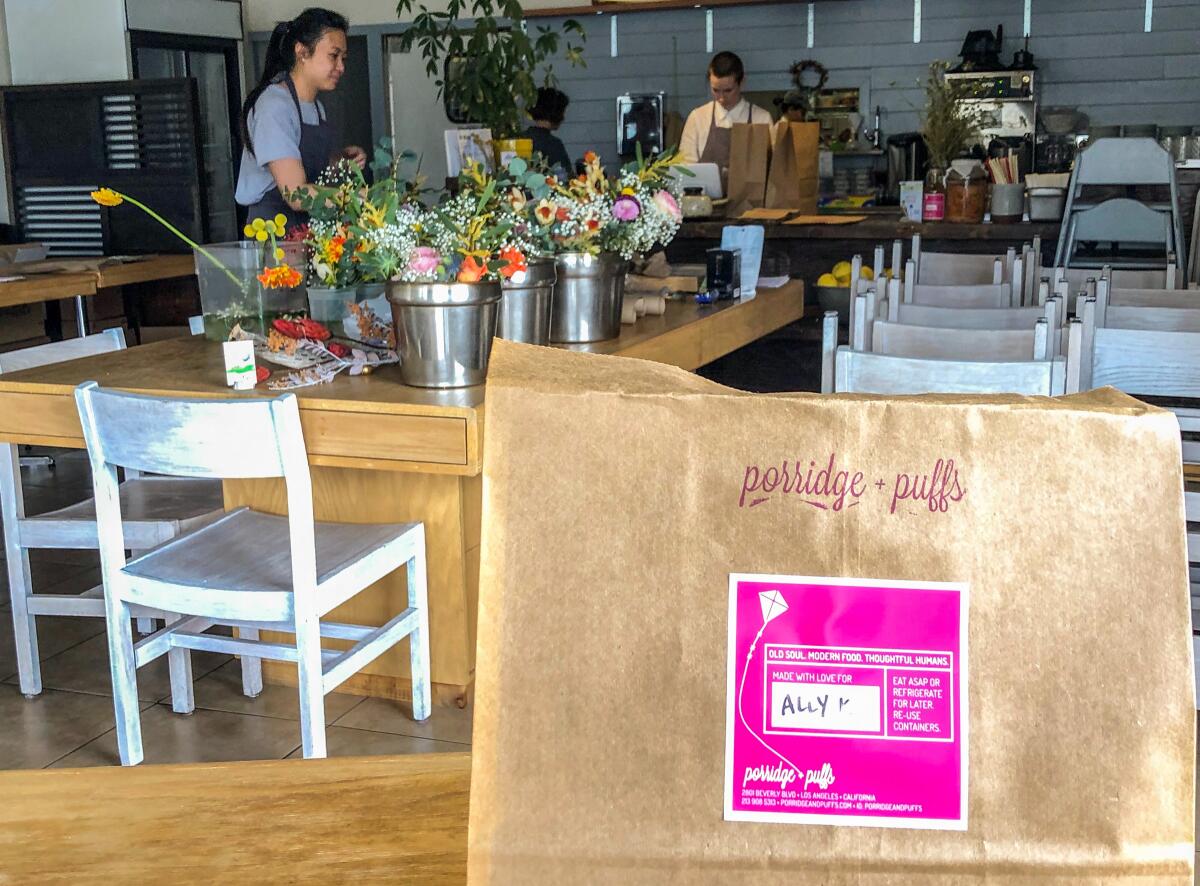 The staff prepares takeout orders at Porridge + Puffs.