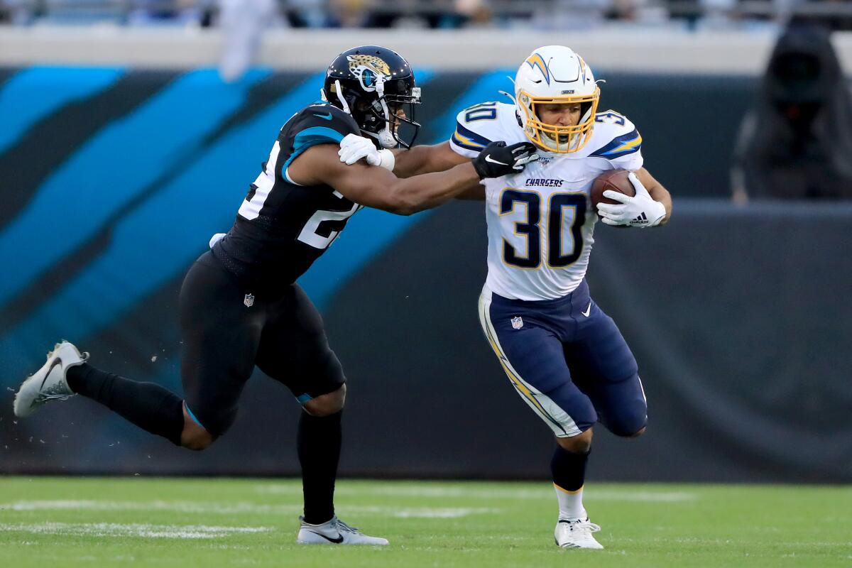 Chargers running back Austin Ekeler tries to push past Jacksonville Jaguars safety Marcus Gilchrist.