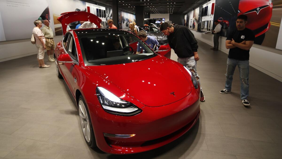 A Model 3 sits on display in a Tesla showroom in July 2018.