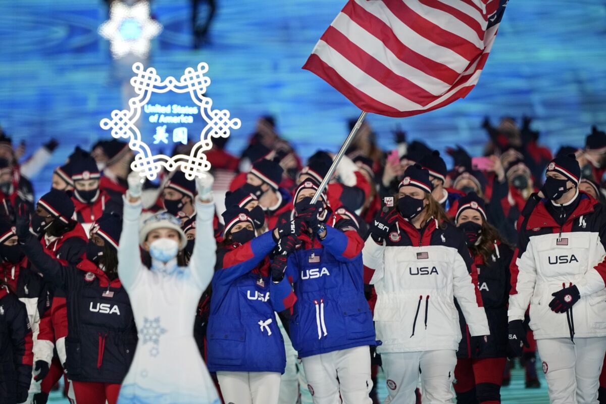 Brittany Bowe and John Shuster, of the United States, leads their team in during the opening ceremony of the 2022 Winter Olympics, Friday, Feb. 4, 2022, in Beijing. (AP Photo/David J. Phillip)