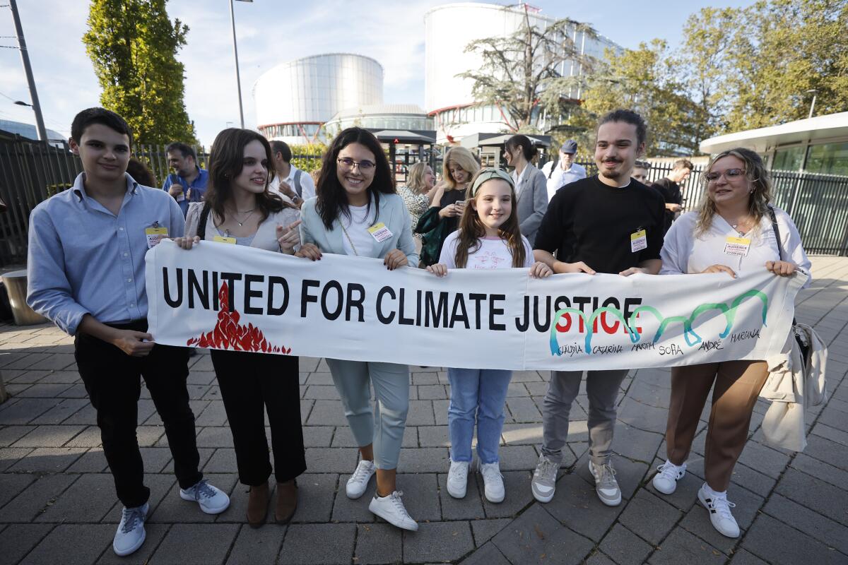 Six young activists hold a banner that reads "United for climate justice." 