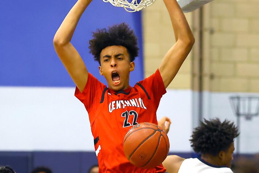 Centennial's Devin Williams dunks during a game in 2021.