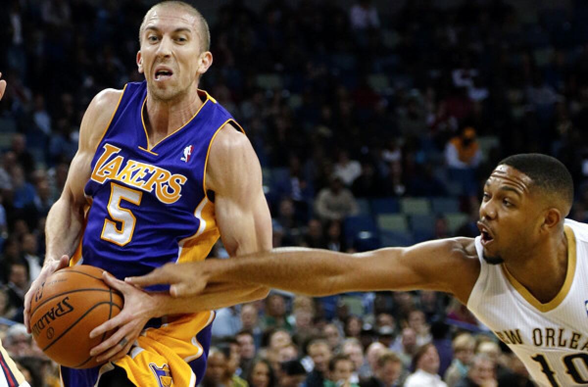 Lakers point guard Steve Blake drives against Pelicans guard Eric Gordon in the first half Friday night in New Orleans.
