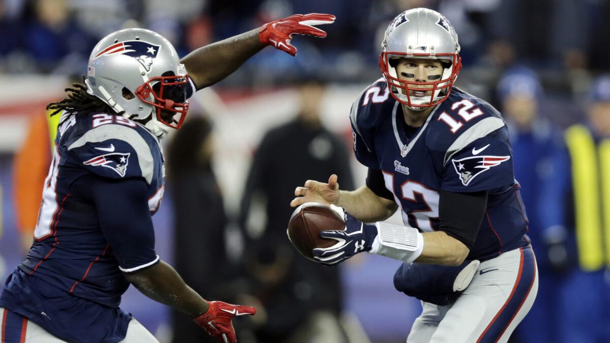 New England Patriots quarterback Tom Brady, right, fakes a handoff to running back LeGarrette Blount during the Patriots' win over the Indianapolis Colts in the AFC Championship game on Sunday.