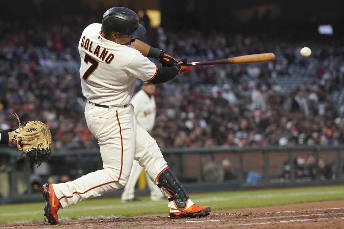 San Francisco Giants' Donovan Solano breaks his bat hitting an RBI-double against the St. Louis Cardinals during the fifth inning of a baseball game in San Francisco, Wednesday, July 7, 2021. (AP Photo/Jeff Chiu)