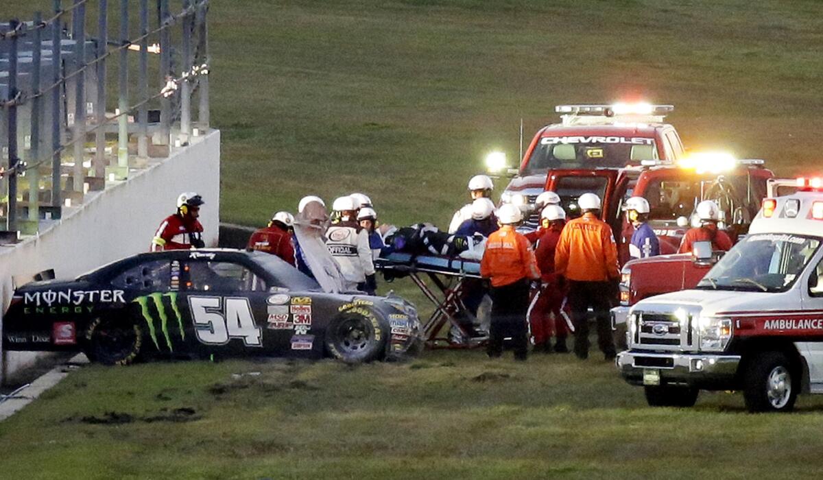 NASCAR driver Kyle Busch is placed on a stretcher after he was involved in a multi-car crash during the Xfinity Series race at Daytona International Speedway on Saturday.