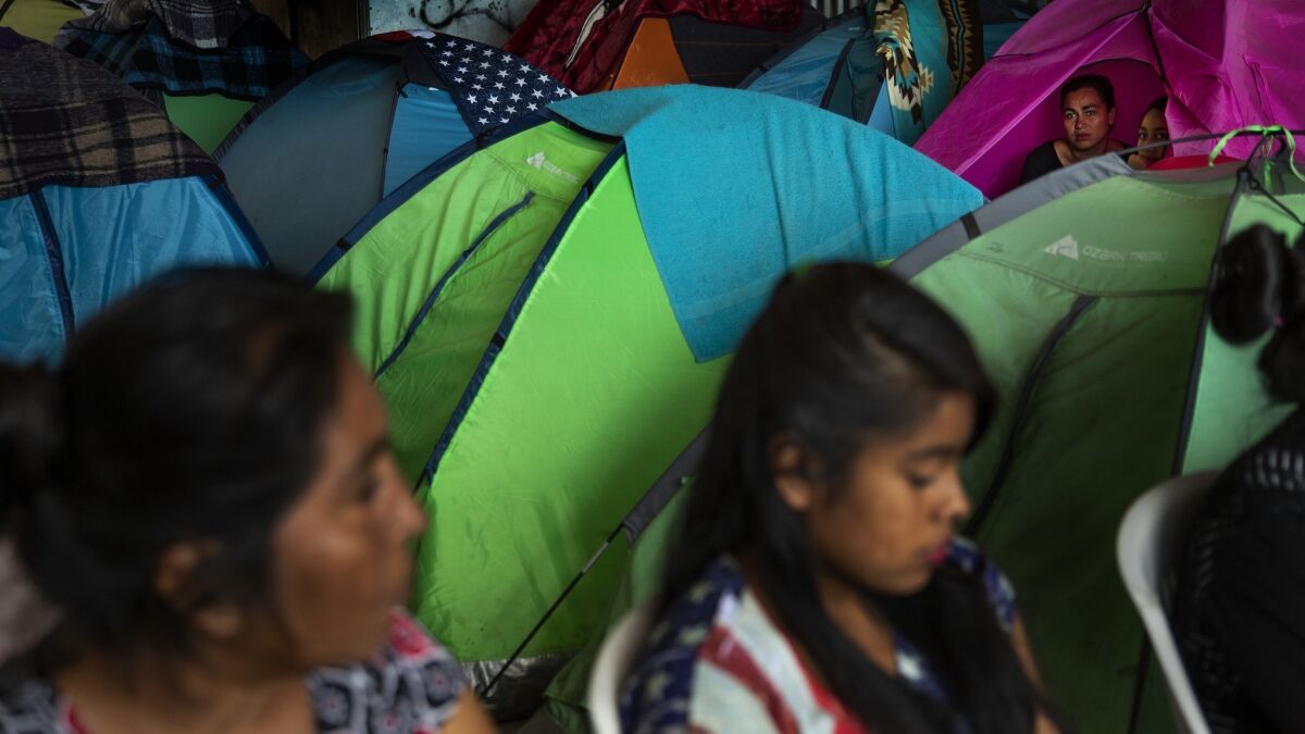 Women and children rest at a border shelter last month in Tijuana.