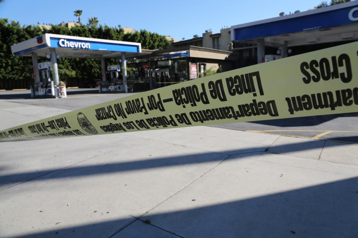 Crime scene tape wraps around the Chevron station mini-mart where a clerk was shot to death during a Jan. 17 robbery.