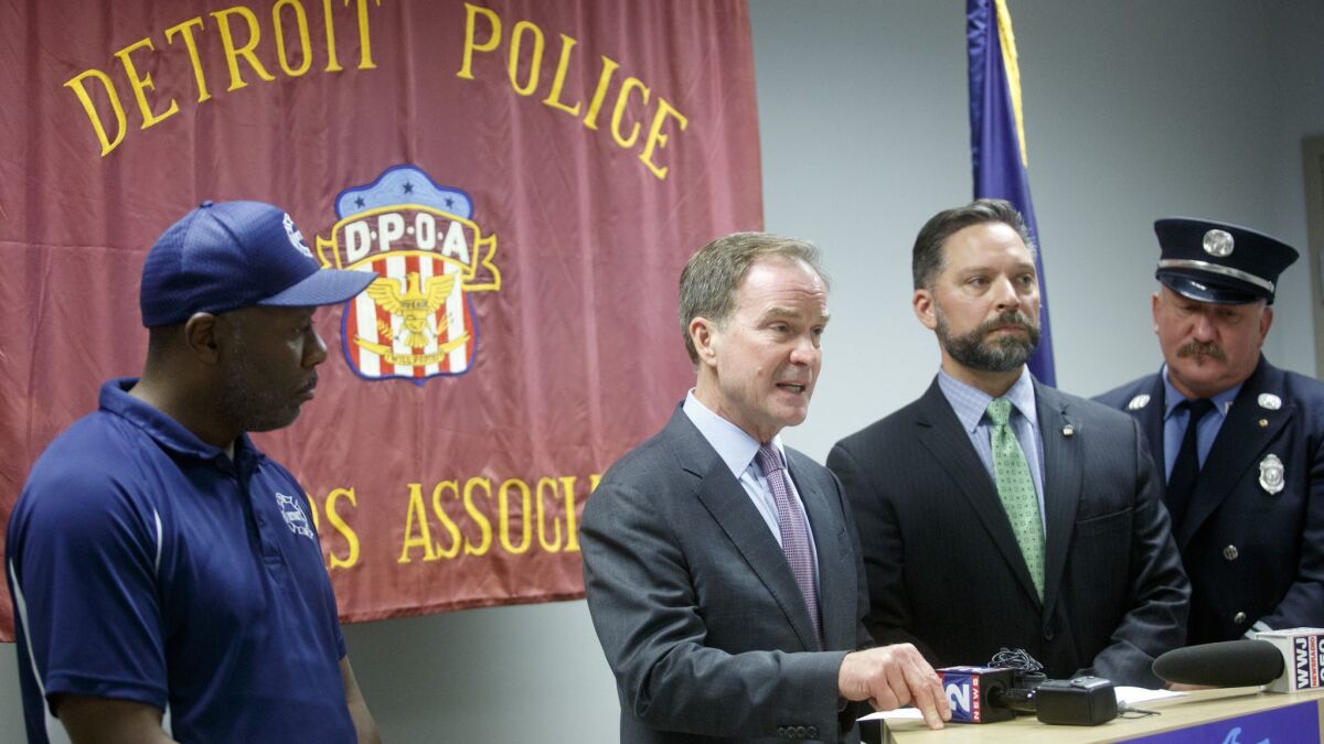 Michigan Atty. Gen. Bill Schuette, center, gestures as he speaks during a campaign event at the Detroit Police Officers Assn. in Detroit on Oct. 4. Schuette is running for governor of Michigan.