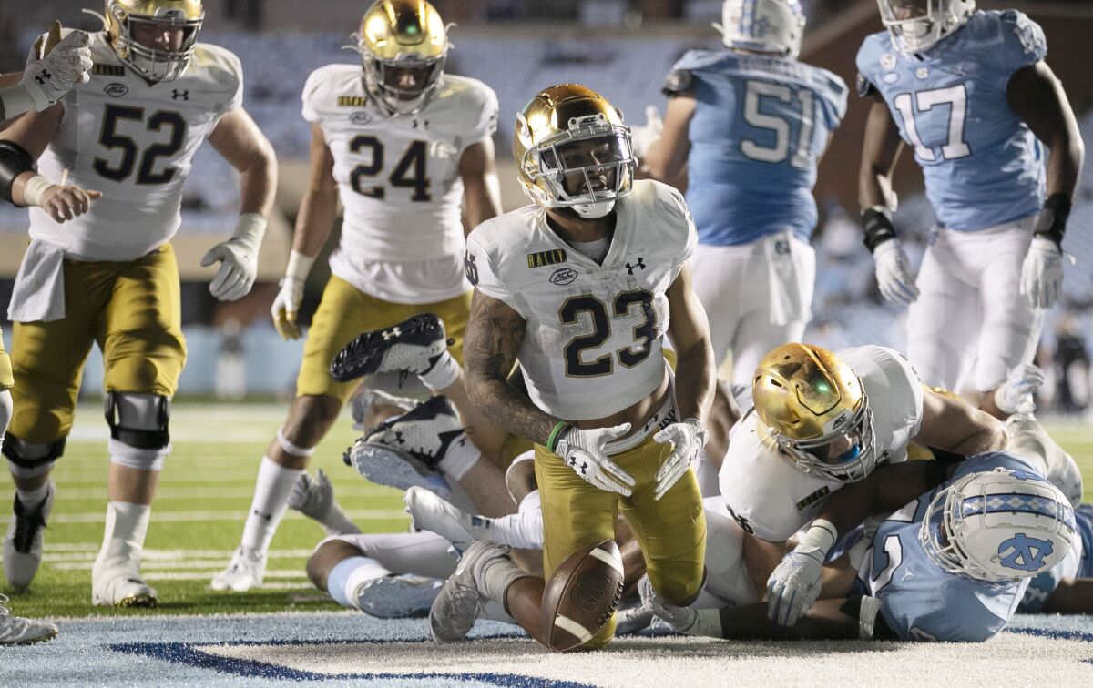 Notre Dame's Kyren Williams (23) reacts after scoring on a 1-yard carry against North Carolina during an NCAA college football game Friday, Nov. 27, 2020, in Chapel Hill, N.C. (Robert Willett/The News & Observer via AP, Pool)