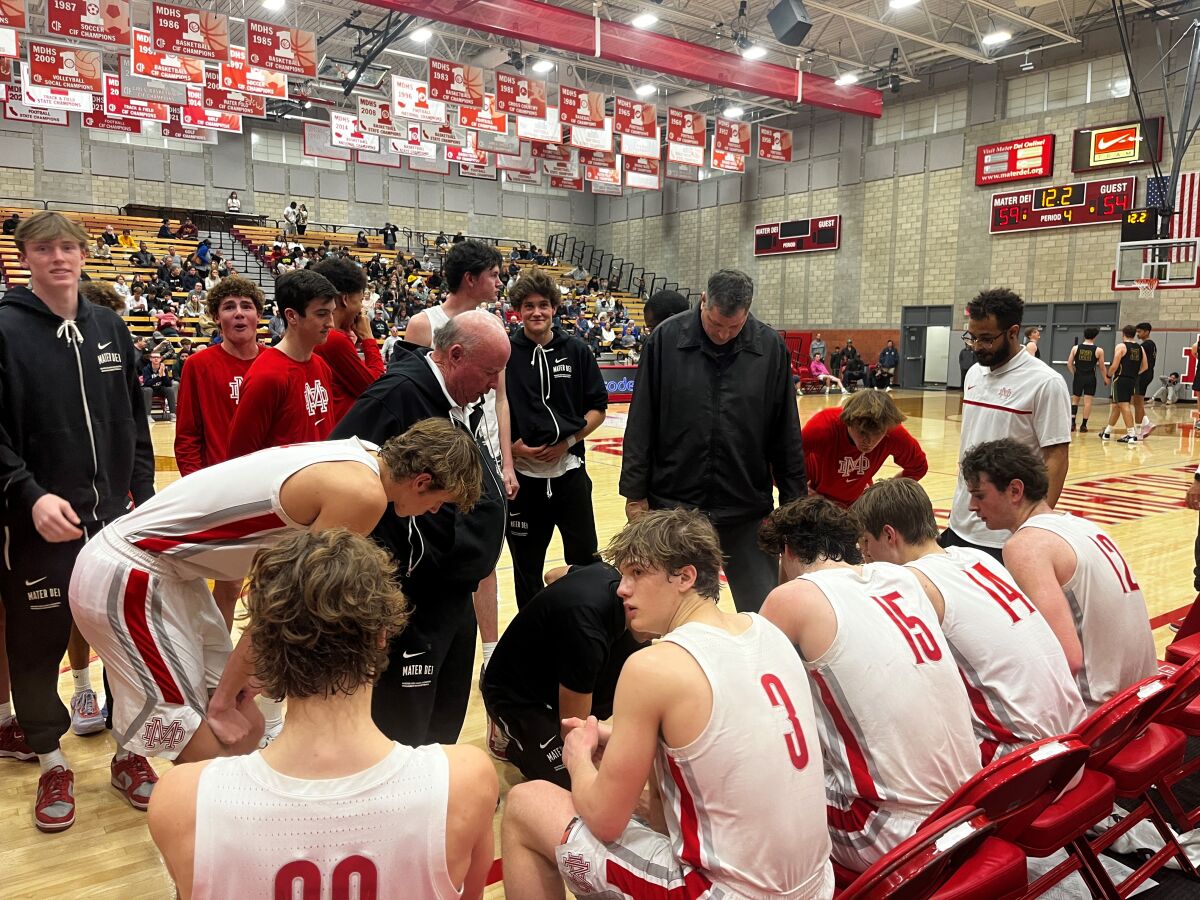 Mater Dei players listen to instructions during a timeout during a playoff game against Mira Costa.