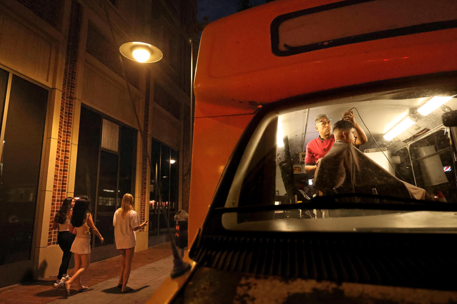 USC students board Hector the Barber's school bus for curbside cuts