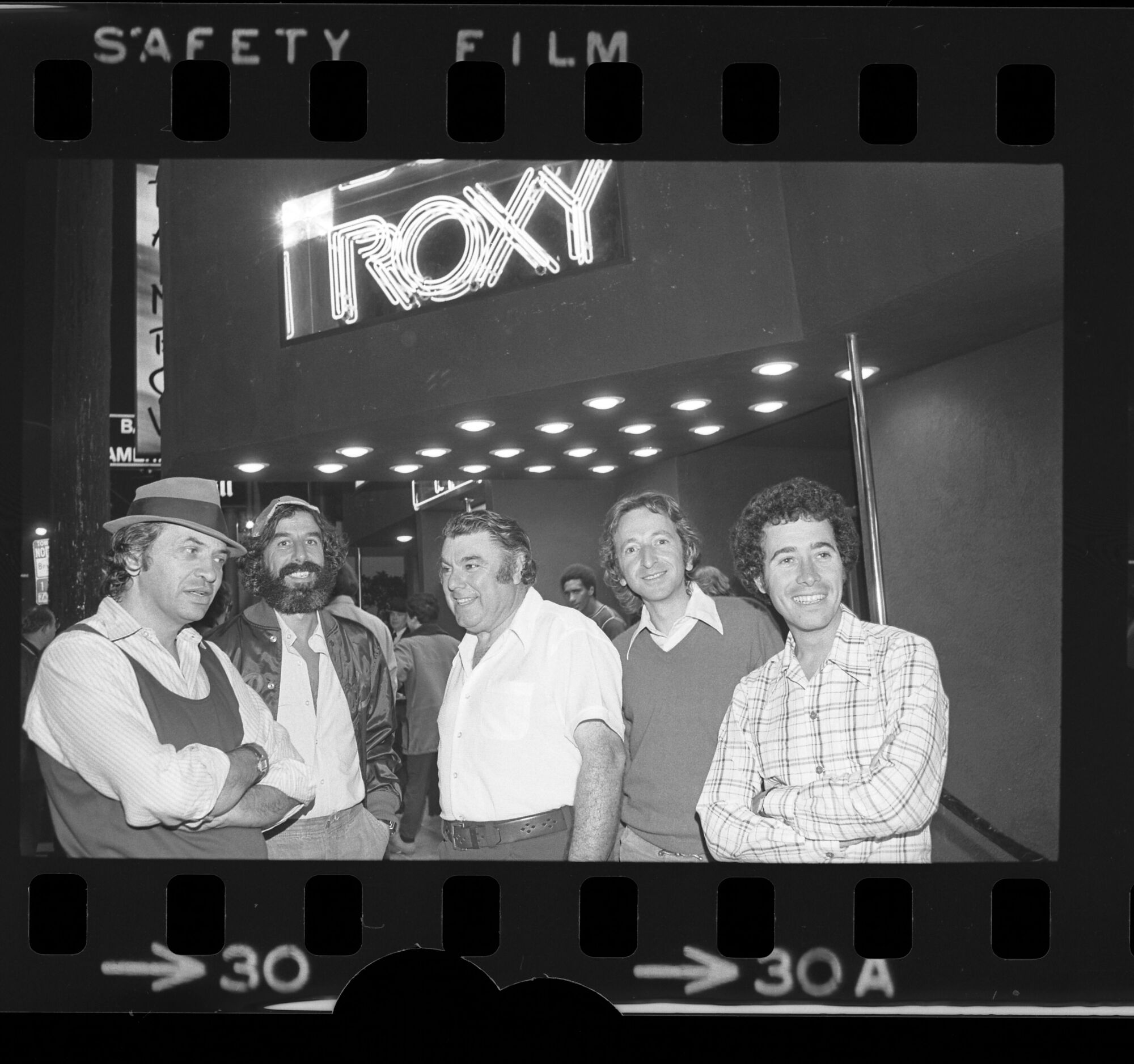 Five men standing under a nightclub marquee in 1973.
