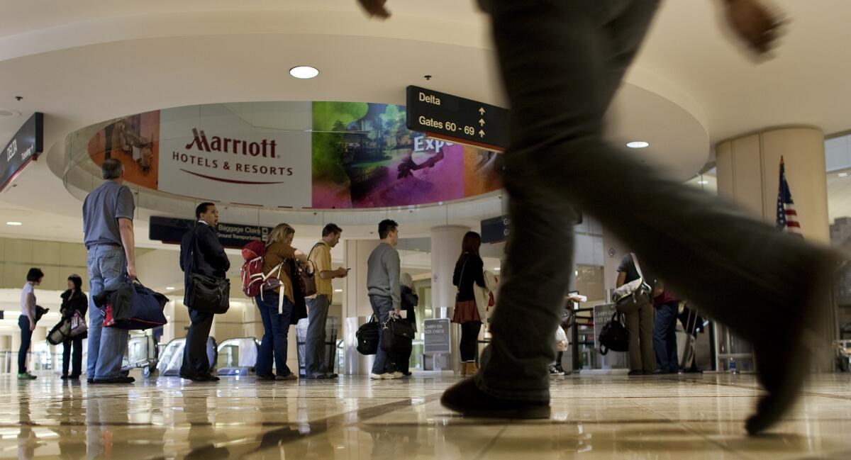 Passengers wait in line to go through security at LAX. TSA says fliers leave goods behind while going through checkpoints and then fail to report the loss.