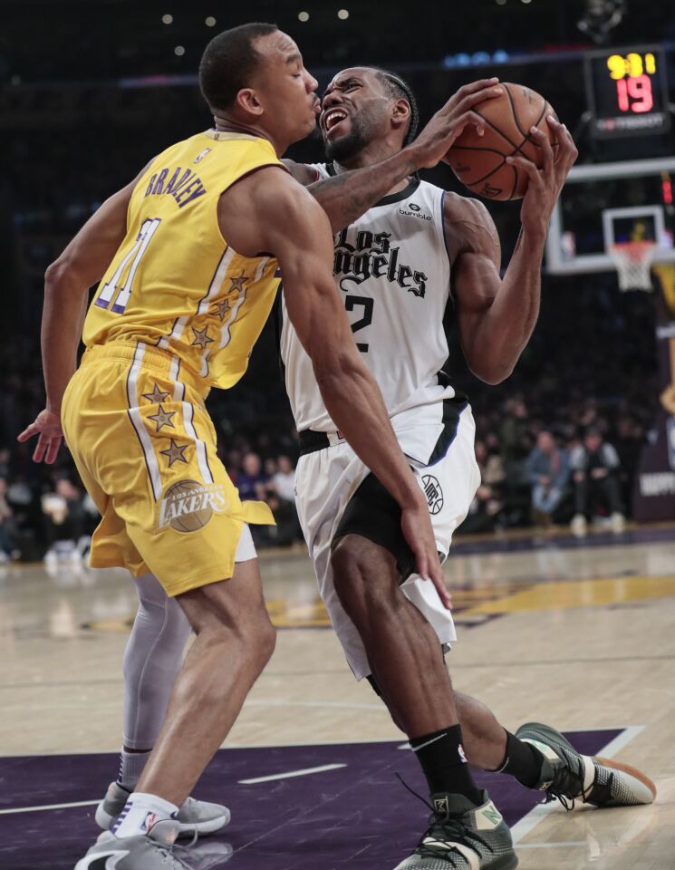 Lakers guard Avery Bradley (11) collides with Clippers forward Kawhi Leonard during the second half.