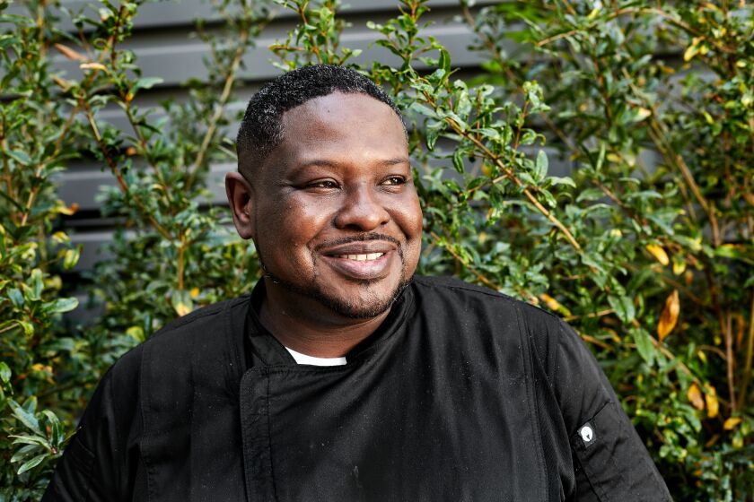 Portrait of Chef Keith Corbin against a background of greenery.
