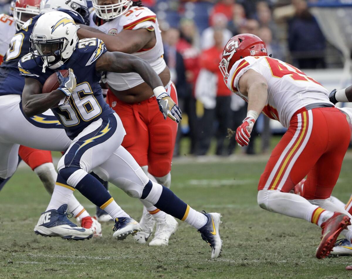 San Diego Chargers running back Ronnie Hillman runs away from Kansas City Chiefs defensive back Daniel Sorensen, right, during the second half of an NFL football game Jan. 1.