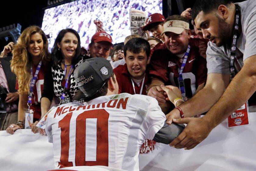 Alabama quarterback AJ McCarron celebrates with family and friends, including girlfriend Katherine Webb, left, after winning the BCS national title on Monday night.